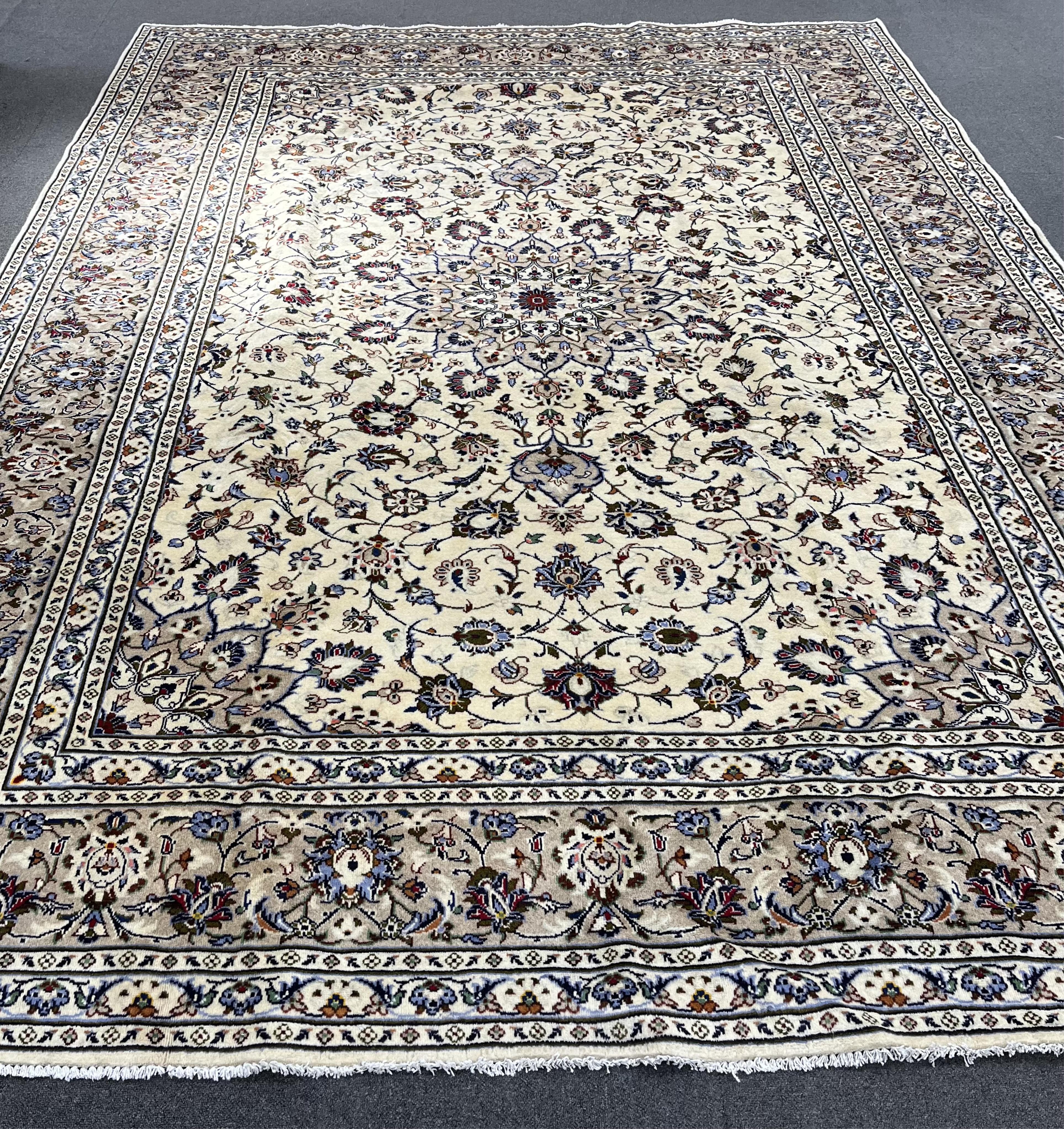 A Kashan ivory ground carpet, 346 x 245. Condition - good